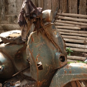 An antique vespa rusts in the yard of a decrepit mansion, Old Dhaka